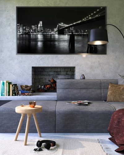 Modern gray living room featuring a fireplace and cityscape artwork, creating a cozy ambiance.
